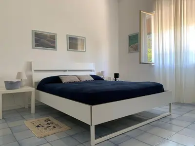 a bedroom with a bed with a blue blanket at Casa Vacanze Astori in Trabia