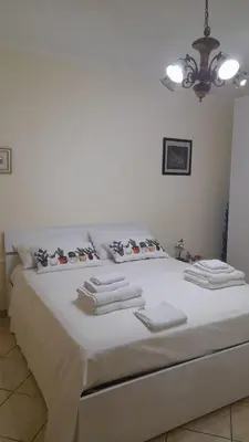 a large white bed with white towels on it at La Villetta di Leonardo, con piscina privata in Campofelice di Roccella
