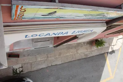 a stack of books sitting on top of a wall at Locanda Lighea Rooms in San Vito lo Capo