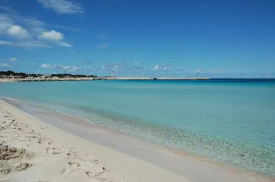 a view of a beach with the blue water at Locanda Lighea Rooms in San Vito lo Capo
