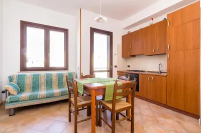 a kitchen with a table and a couch at Casa Irene in San Vito lo Capo