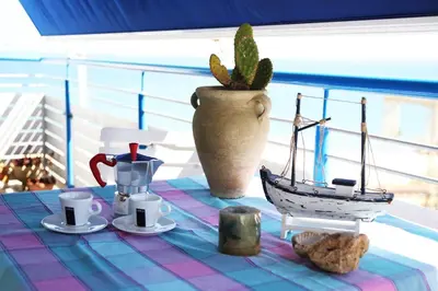 a table with a table cloth with a toy boat on it at Appartamento Il Gabbiano in Balestrate