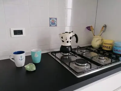 a stove top with a tea pot on top of it at Appartamento Il Gabbiano in Balestrate