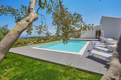 a villa with a swimming pool and lounge chairs at Villa dell'Artista in Scopello