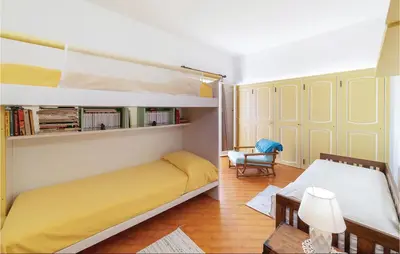 a bedroom with a bunk bed and a chair at Villa Kericia in Porticello