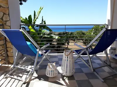 a balcony with chairs and a view of the ocean at Villa Belvedere Michelle in Trappeto