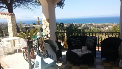 a balcony with chairs and a view of the ocean at Villa Belvedere Michelle in Trappeto