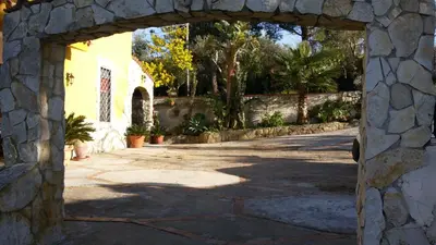 an entrance to a stone building with an archway at Villa Belvedere Michelle in Trappeto