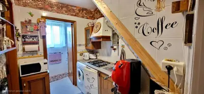 a small kitchen with a stove and a staircase at Grazioso appartamento nel cuore di Palermo in Palermo