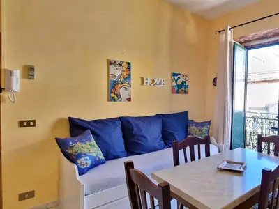a living room with a blue couch and a table at Grazioso appartamento nel cuore di Palermo in Palermo