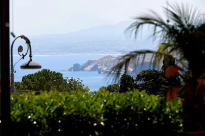 a view of a large body of water with a lamp at Baglio Dello Zingaro in Scopello