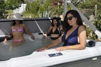 three women in bathing suits in a hot tub at Baglio Dello Zingaro in Scopello