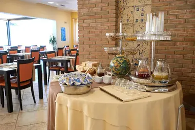 a table in a restaurant with a white table cloth at Baglio Dello Zingaro in Scopello