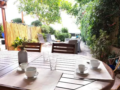 a wooden table with cups and saucers on it at Villa Caterina in Mondello