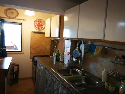 a kitchen with a sink and a counter top at Villa Caterina in Mondello
