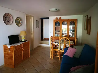 a living room with a couch and a table with a laptop at Villa Caterina in Mondello