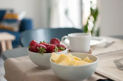 two bowls of fruit and two cups on a table at Dietro il Teatro in Palermo