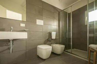 a bathroom with a toilet and a sink and a shower at Dietro il Teatro in Palermo