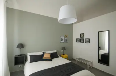 a bedroom with a large bed and a mirror at Dietro il Teatro in Palermo