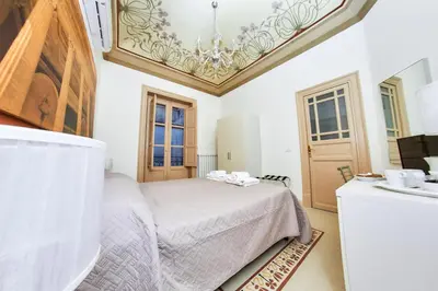 a bedroom with a bed and a sink at Solemar Sicilia - Monacò rooms in Palermo