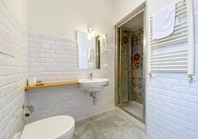 a white bathroom with a toilet and a sink at Solemar Sicilia - Monacò rooms in Palermo