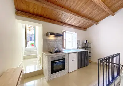 a kitchen with a stove top oven in a room at Solemar Sicilia - Monacò rooms in Palermo