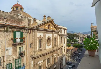 an old building with a dome on top of it at Kalsa Casa di Charme con terrazza by Wonderful Italy in Palermo