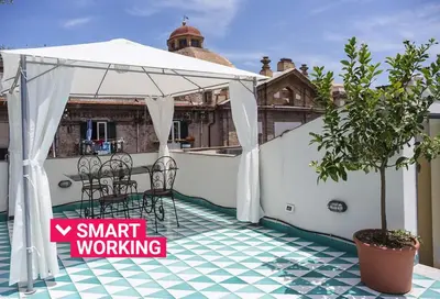 a white canopy on a balcony with a table and chairs at Kalsa Casa di Charme con terrazza by Wonderful Italy in Palermo