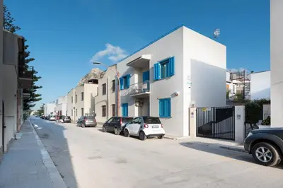 a street with cars parked in front of buildings at B&B Reef and Dream in San Vito lo Capo