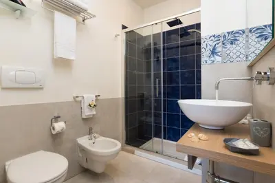 a bathroom with a sink and a toilet and a shower at B&B Reef and Dream in San Vito lo Capo