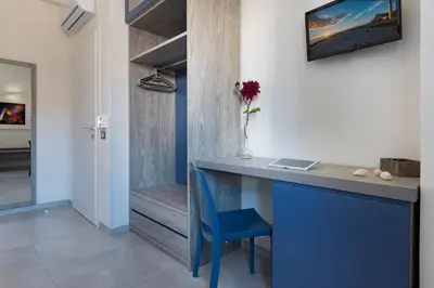 a blue desk with a blue chair in a room at B&B Reef and Dream in San Vito lo Capo