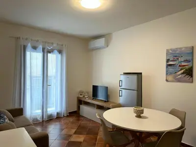 a living room with a table and a tv at Appartamenti-Residence Al Massimo in Palermo