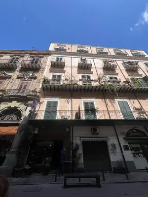 a blue sign hanging on a wall at Casa di Cocò in Palermo