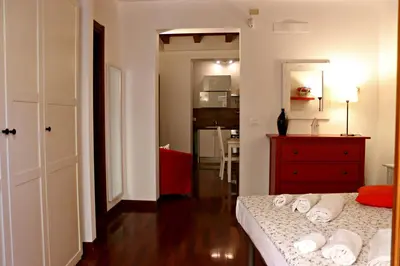a bedroom with a bed and a red dresser at La Casetta di Clara in Palermo