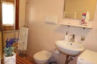 a bathroom with a sink and a toilet and a mirror at La Casetta di Clara in Palermo