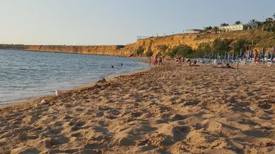 a group of people on a beach near the water at B&B Cinisi Vacanze 2.0 in Cinisi