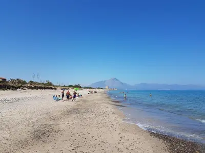 a group of people standing on a beach at Mansarda con Vista Piscina in Campofelice di Roccella