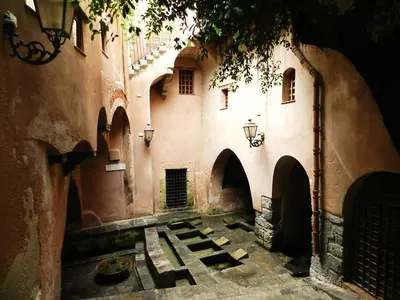 an alley way in an old building with arches at Mansarda con Vista Piscina in Campofelice di Roccella