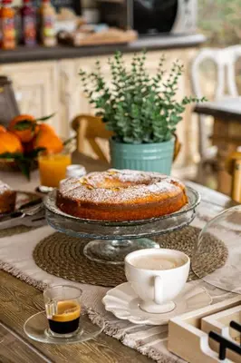 a cup of coffee on a table with a vase at Grotta dei Puntali B&B in Carini