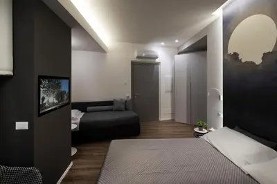 a bedroom with a bed and a couch in it at B&B In Centro Palermo in Palermo