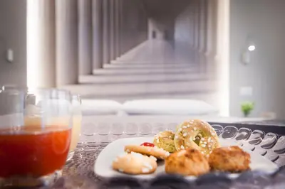 a table with a plate of food and a drink at B&B In Centro Palermo in Palermo
