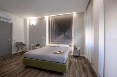 a bedroom with a bed with a staircase in the background at B&B In Centro Palermo in Palermo
