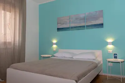 a bedroom with a bed with blue lights on it at Mondello Beach Rooms - by the sea in Mondello