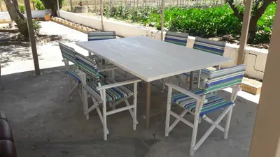 a table with four chairs and a table and a table at Casa Vacanze Reginotte in Balestrate