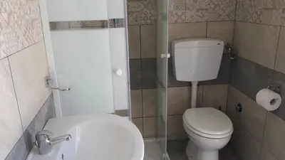 a small bathroom with a toilet and a sink at Casa Vacanze Reginotte in Balestrate