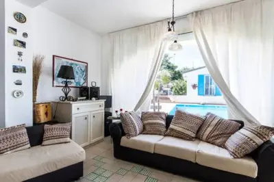a living room with a couch and a large window at Villa Mare Ficarazzi in Ficarazzi