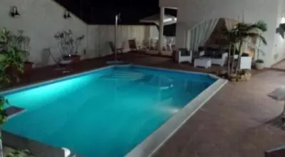 a large blue swimming pool in a building at Villa Mare Ficarazzi in Ficarazzi