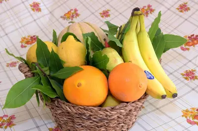 a basket of fruit with bananas oranges and pears at Villa Pinella in Palermo