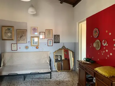 a view of a patio with flowers and a table at Casa pergj in Palermo