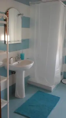 a bathroom with a sink and a shower with a mirror at La sterlizia in Mondello